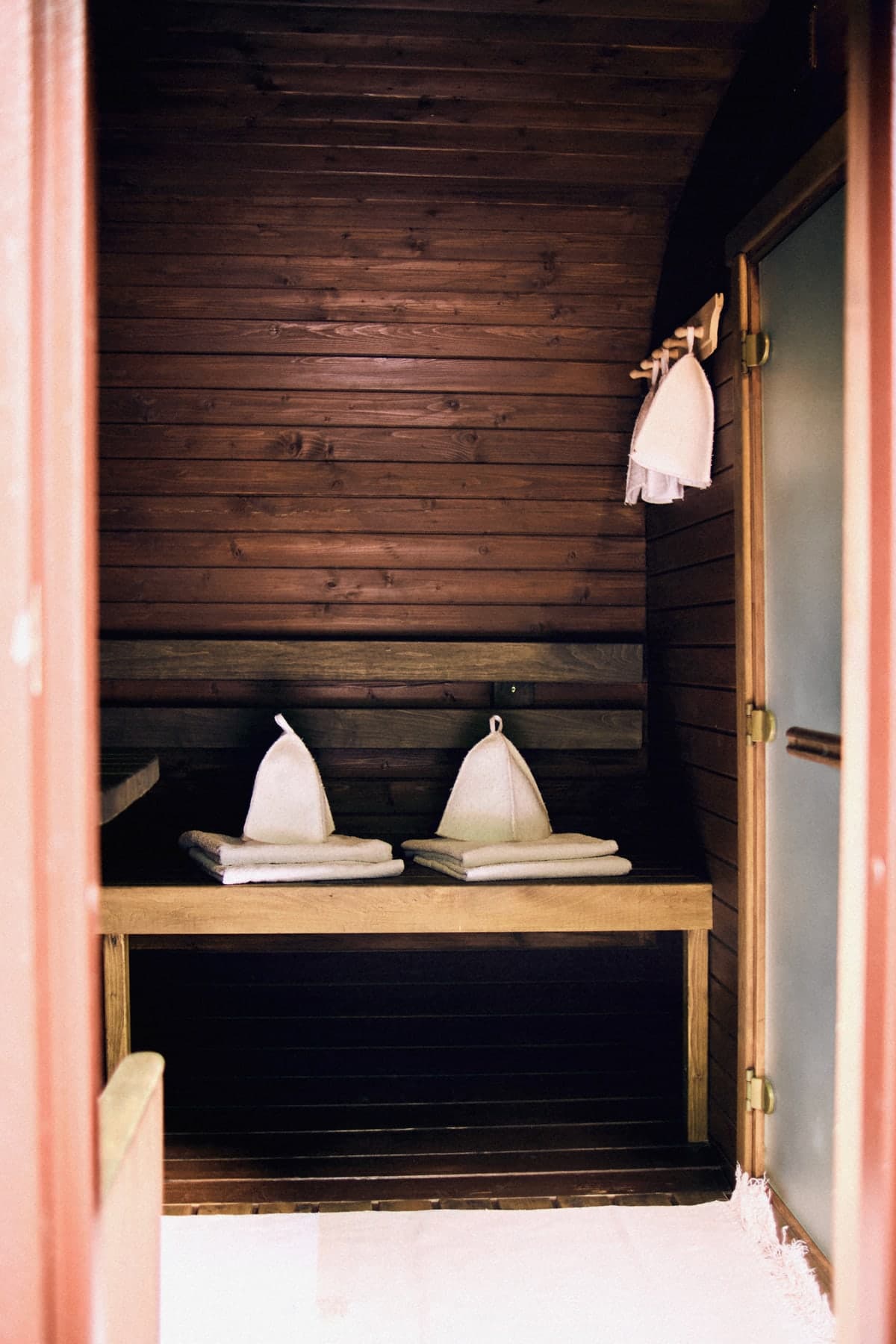 Sauna hats and towels on a bench in the changing room