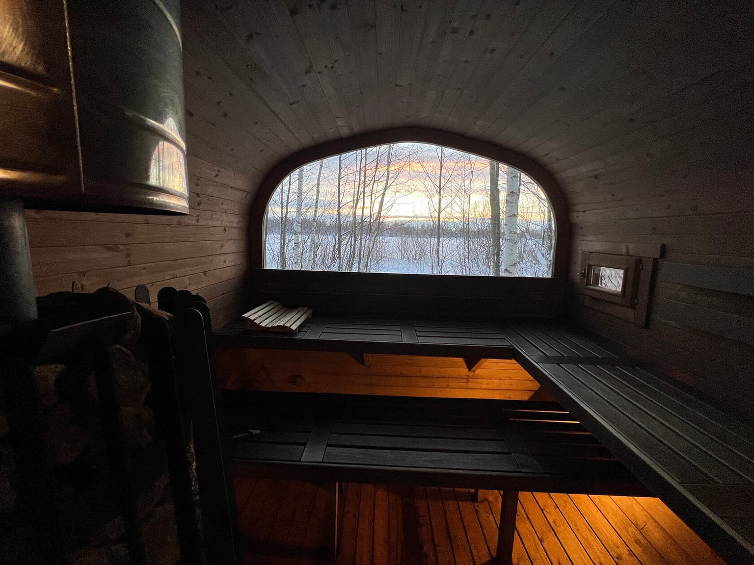 Steam room with an arched window onto the water