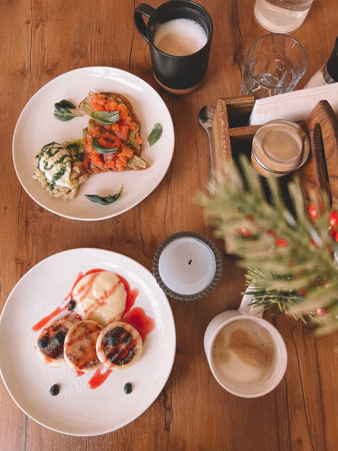 Syrniki and fried eggs with coffee on a wooden table