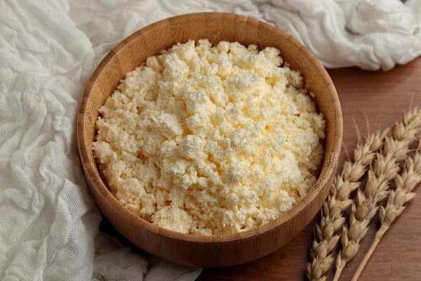 Curd cheese in a wooden bowl