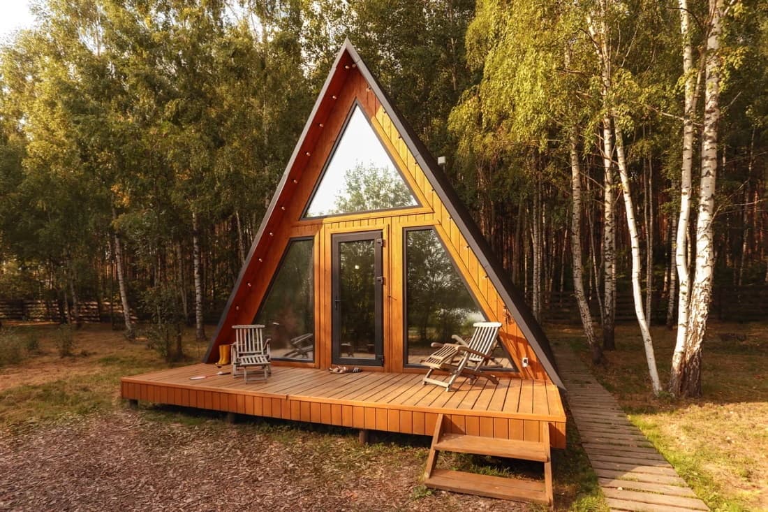 An A‑frame cabin in the sunlight